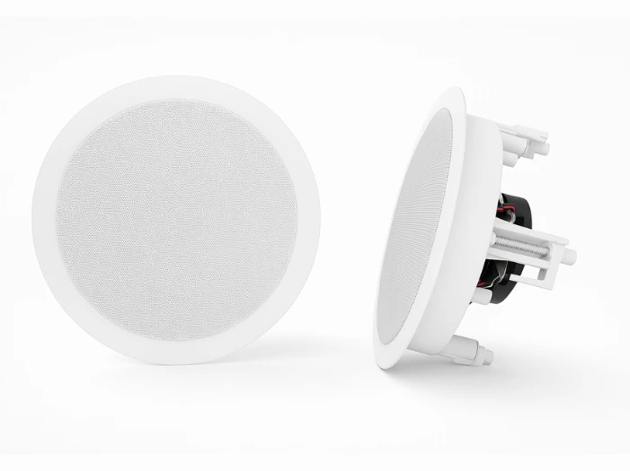 Recessed white circular-shaped audio speakers.